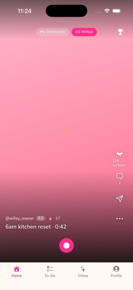 Trad Wife's full-screen pulse feed showing a task-stamped video, curtsy and comment counts, and the record button